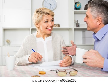 Man And Woman 50-54 Years Old Are Lead Discussion About Agreement Of The Credit. 