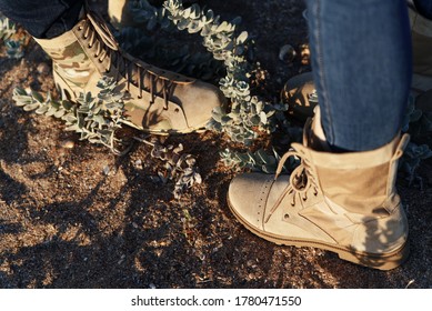 Man And Woman In Army Beige Boots Spend Outdoor Activities In The Wilderness. Caucasus, Russia