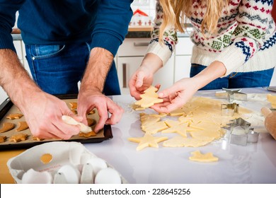 Man and woman baking Christmas cookies at home in domestic kitchen  - Powered by Shutterstock