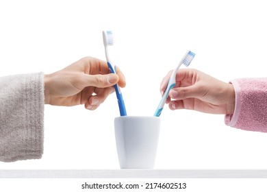 Man and woman in bathrobe, they are taking their brushes in in the brush holder, Isolated on white background - Powered by Shutterstock