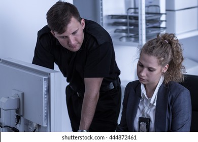 Man And Woman Beside Computer, Working At A Police Station 