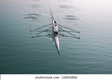 Man And Woman In A Boat, Rowing On The Tranquil Lake