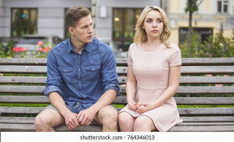 Man And Woman Breaking Up On Bench In Park, Conflict In Relationship, Problem