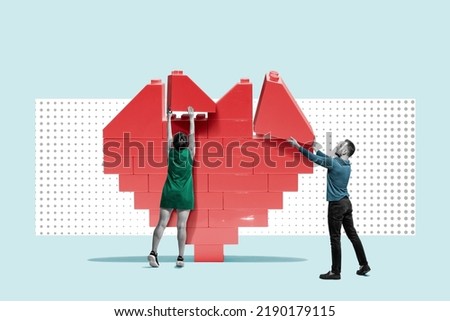 A man and a woman are building a heart from a constructor.
