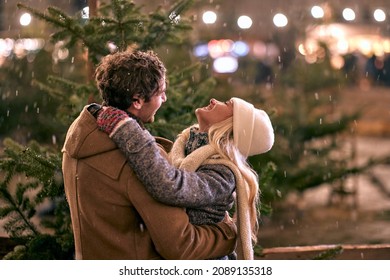 Man and woman buying christmas beautiful tree