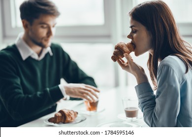 Man and woman cafe eating croissant breakfast  - Shutterstock ID 1784595146