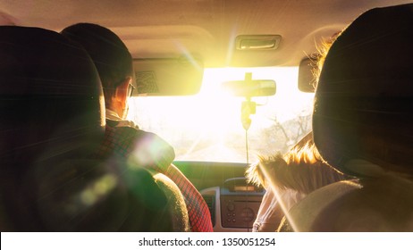 The Man And The Woman In The Car Rush Towards To The Dazzling Sun