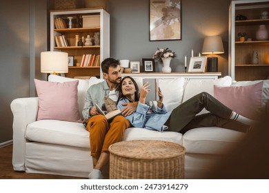 man and woman caucasian adult couple read books at home on sofa bed	 - Powered by Shutterstock