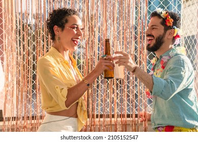 Man and woman celebrating carnival at home. Couple toasting and celebrating Carnaval. - Shutterstock ID 2105152547