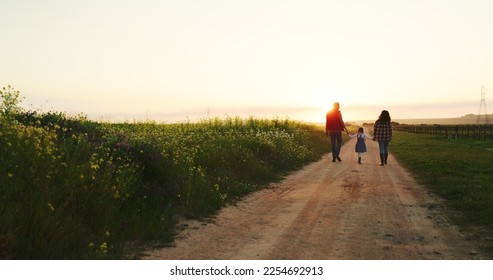 Man, woman or child holding hands on farm and sunset walking on nature environment path, agriculture dirt road or countryside soil. Farming family, girl or parents bonding on sustainability landscape - Powered by Shutterstock