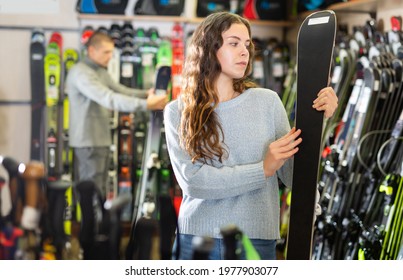 Man And A Woman Are Choosing New Models Of Skis In The Ski Equipment Store