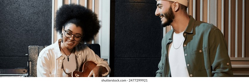 A man and a woman collaborate in a recording studio, working on music for their band rehearsal. - Powered by Shutterstock