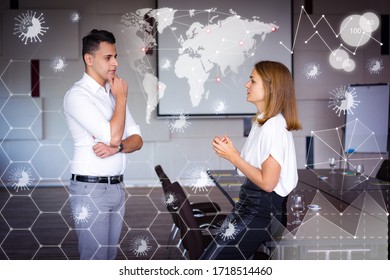 Man And Woman In Conference Hall And Virtual Pandemic Graphics. Young Caucasian Businesswoman Sitting On Table And Talking To Male Colleague. Business Relationship Concept