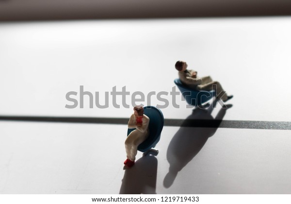 Man and woman in conflict. Divided or divorced
couple. Two people in need of therapy or counselling. Male and
female disagreement or argument. Division or separation between the
genders with shadows.