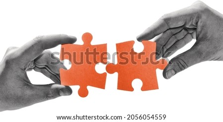 A man and a woman are connecting pieces of the puzzle. Human relations, compatibility, trust, team. Concept.