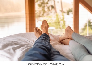 Man woman couple feet lying in bed resting enjoying weekend morning relaxing  - Powered by Shutterstock