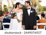 Man, woman and couple holding hands at wedding ceremony with flower bouquet, marriage or celebration. Bride, groom and guests at outdoor park or party for summer reception, backyard or commitment