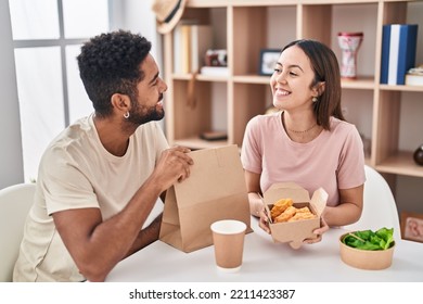 Man And Woman Couple Sitting On Table Eating Take Away Food At Home