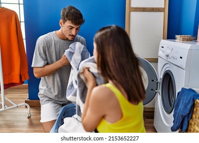 Man And Woman Couple Washing Clothes Smelling Towel At Laundry Room