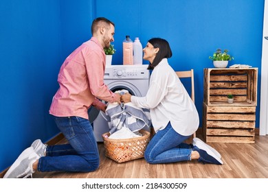 Man And Woman Couple Washing Clothes At Laundry Room