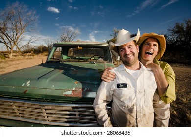 Man And Woman In Cowboy Hats With Old Truck