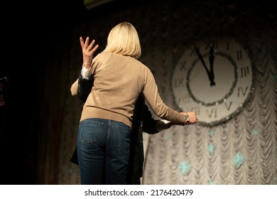 Man And Woman Dance In Front Of Clock. Middle-aged Couple. Dance Lesson On Stage. Adult Relationships.