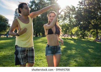 Man And Woman Dancing Latin American In Park 