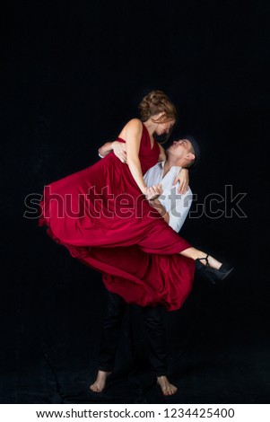 man and woman dancing Latin, ballroom dancing in a pair on a black background, dance moves