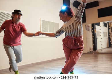 A Man And A Woman Dancing Lindy Hop In A Dance Studio