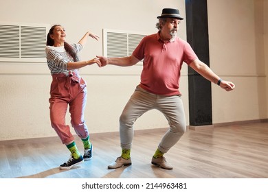 A Man And A Woman Dancing Lindy Hop In A Dance Studio