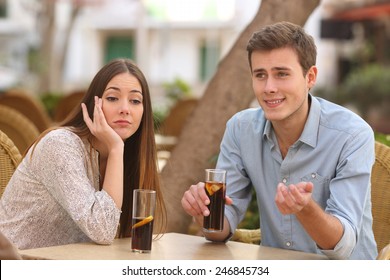 Man and woman dating in a restaurant terrace but she is boring while he telling lies with the street in the background