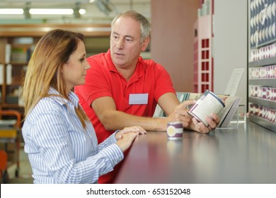 Man And Woman Discussing New Paint Colors