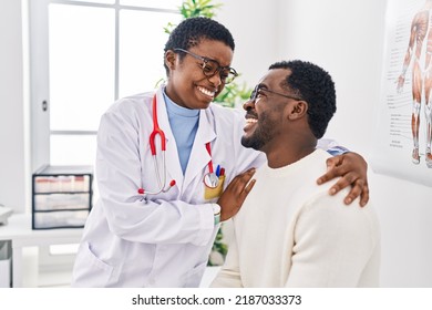 Man and woman doctor and patient having medical consultation hugging each other at clinic - Powered by Shutterstock