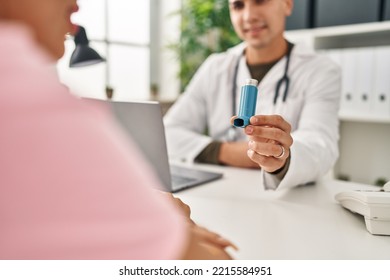 Man and woman doctor and patient having medical consultation holding inhaler at clinic - Powered by Shutterstock