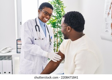 Man and woman doctor and patient putting band aid at clinic - Powered by Shutterstock