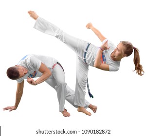 Man and woman does the fighting element of capoeira. A couple of fighters train capoeira isolated on white background - concept about people, lifestyle and sport.