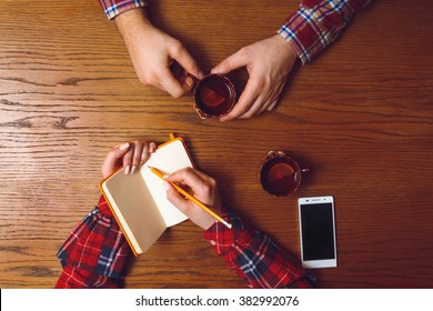 Man And Woman Drinking Tea In A Cafe In The Interview Process In A Cafe.