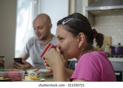 Man And Woman Drinking Tea In The Kitchen. 