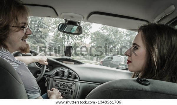 Man and woman
during traveling trip. Couple, friends sitting inside vehicle car
driving riding somewhere.