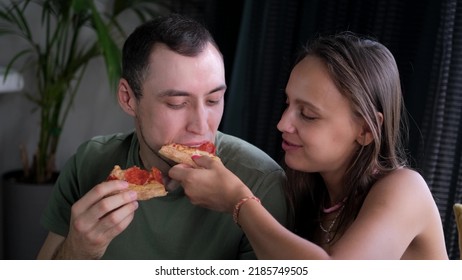 Man And Woman Eat Pizza At Home. Ready Meal Delivery Concept. Fast Food