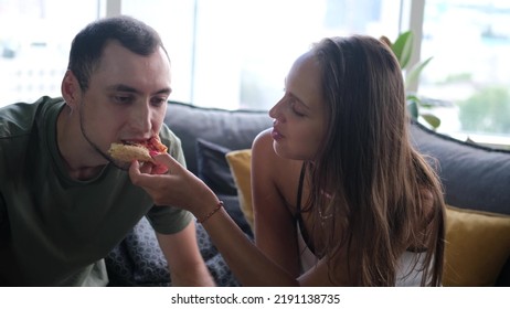 Man And Woman Eat Pizza At Home. Ready Meal Delivery Concept. Fast Food