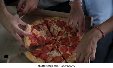 Man And Woman Eat Pizza At Home. Ready Meal Delivery Concept. Fast Food. Close-up