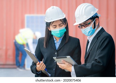 Man And Woman Engineers And Workers Using Tablet Device And Meeting At Rooftop Of Solar Cell Panel In Background. Asian, People Operate On Site Renewable Energy Construction.