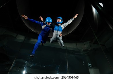 A Man And A Woman Enjoy Flying Together In A Wind Tunnel. Free Fall Simulator