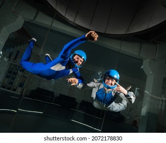 A Man And A Woman Enjoy Flying Together In A Wind Tunnel. Free Fall Simulator