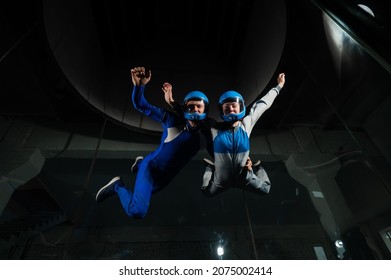 A Man And A Woman Enjoy Flying Together In A Wind Tunnel. Free Fall Simulator