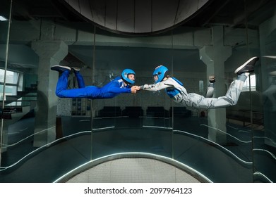 A Man And A Woman Enjoy Flying Together In A Wind Tunnel. Free Fall Simulator