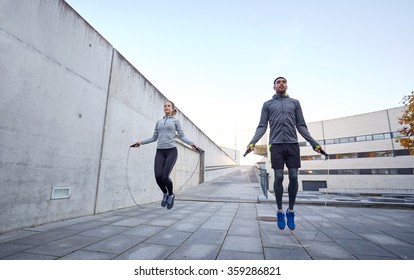 man and woman exercising with jump-rope outdoors - Powered by Shutterstock