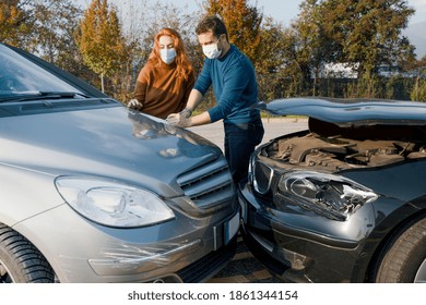 Man And Woman Filling An Insurance Car Report After Car Crash Wearing Face Mask For Corona