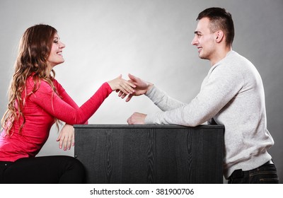 Man And Woman First Date Meeting. Handshake Greeting. Male And Female Shaking Hands And Getting To Know Each Other. 